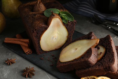 Tasty pear bread with spices and mint on grey table. Homemade cake