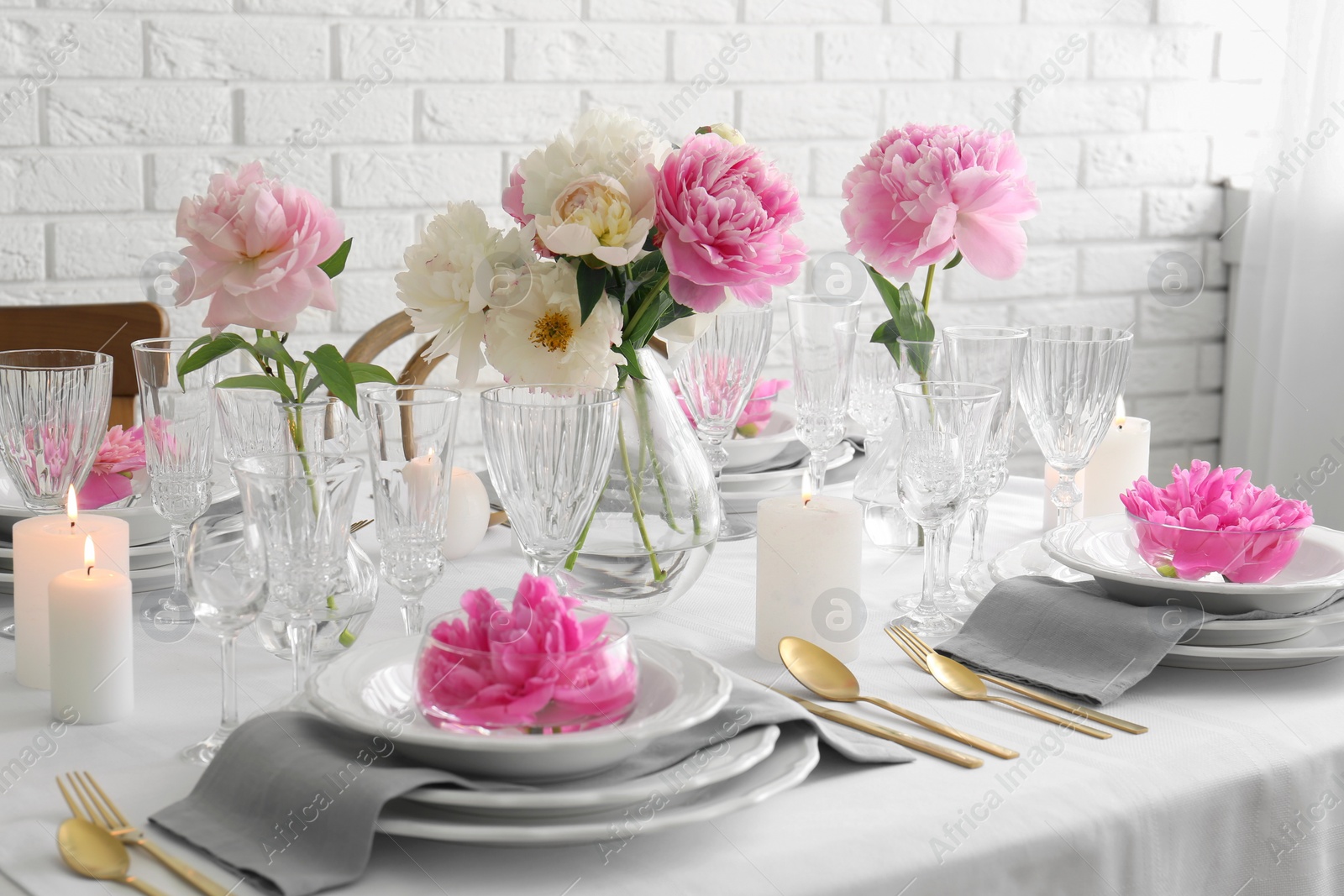 Photo of Stylish table setting with beautiful peonies in dining room