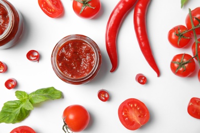 Composition with tasty homemade tomato sauce on white background, top view