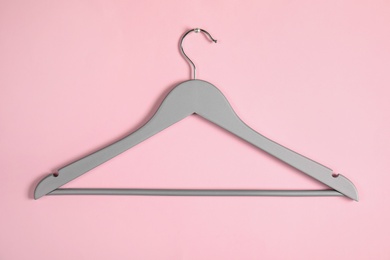 Photo of Empty clothes hanger on color background. Wardrobe accessory