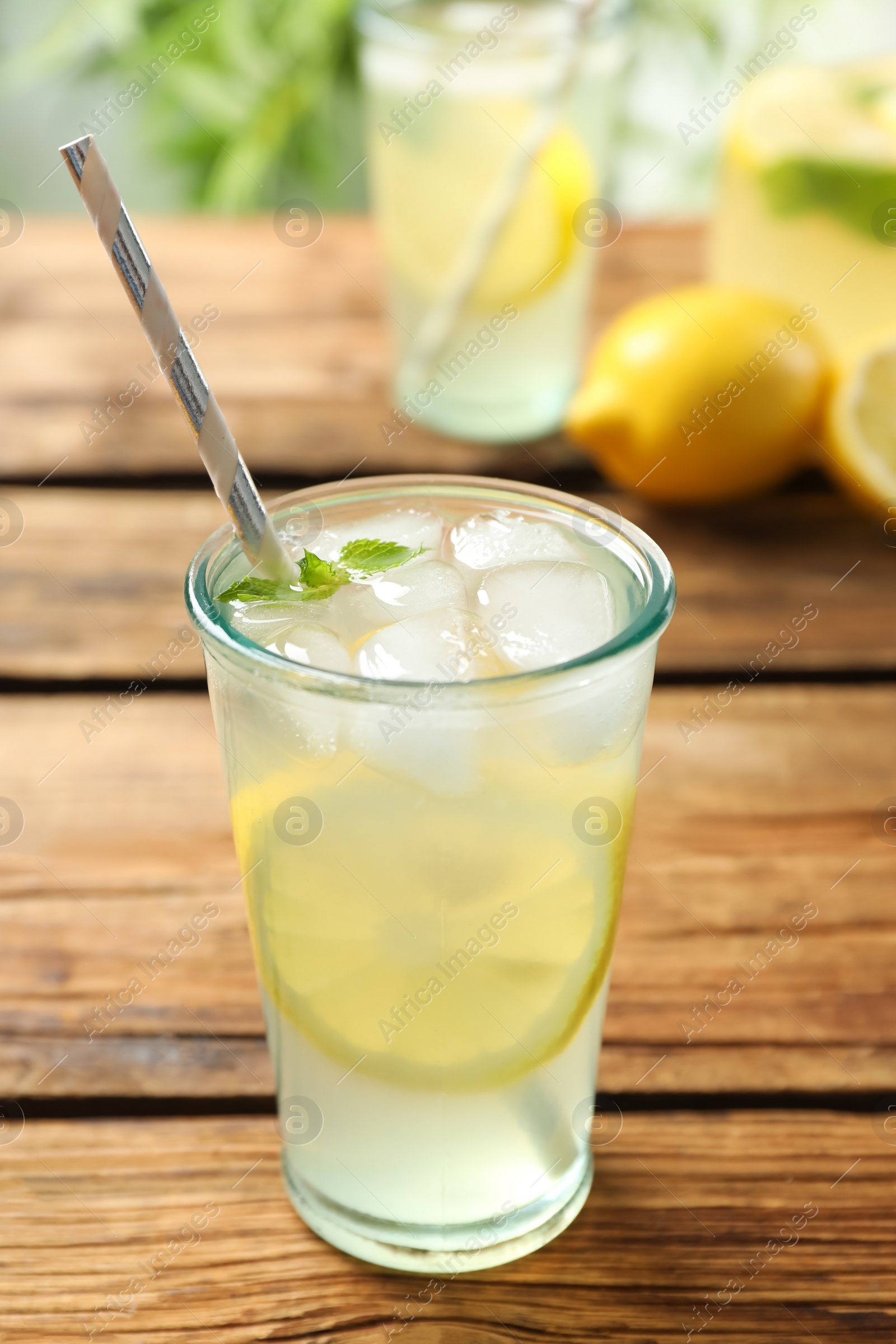 Photo of Natural lemonade with mint on wooden table. Summer refreshing drink