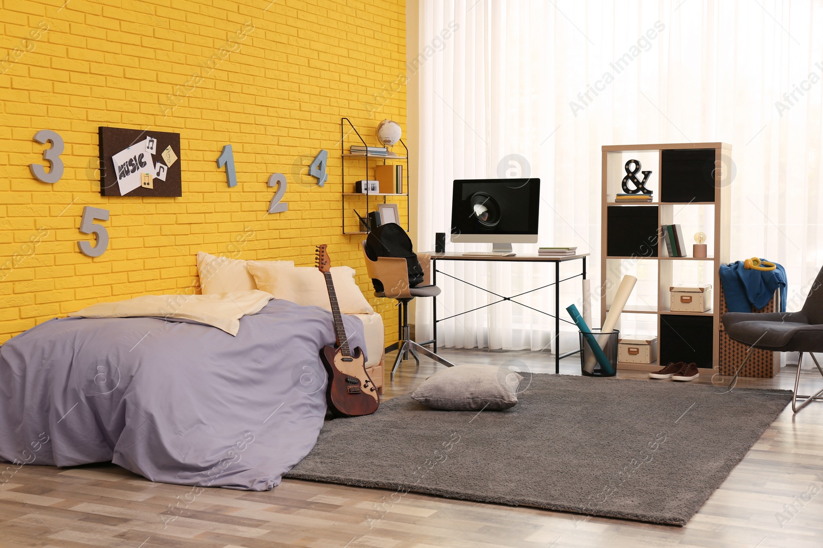 Photo of Stylish teenager's room interior with computer and bed