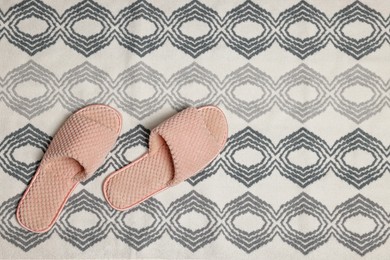 Slippers on soft bath mat, flat lay. Space for text