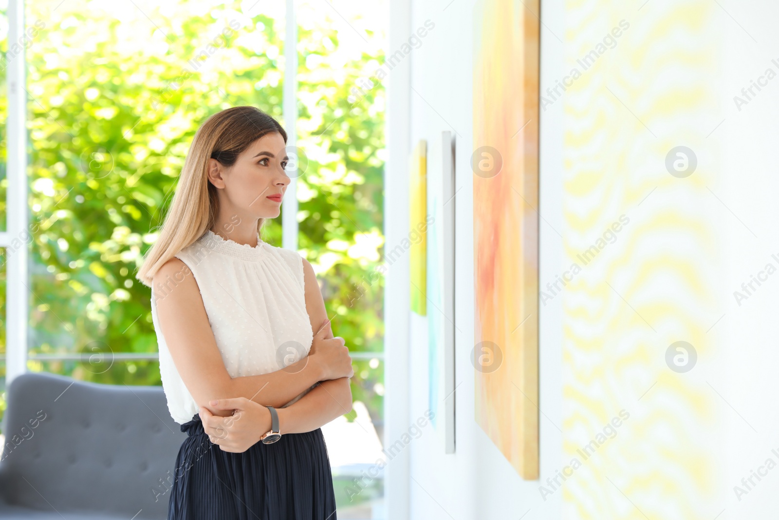 Photo of Beautiful woman at exhibition in art gallery