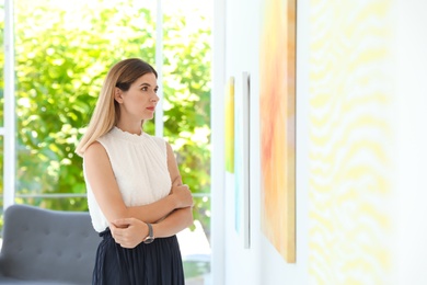 Beautiful woman at exhibition in art gallery