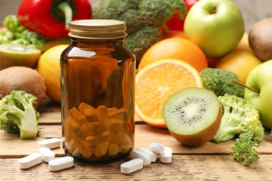 Dietary supplements. Bottle, pills and food products on wooden table