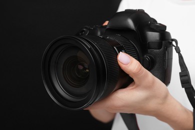 Photo of Photographer with camera on black background, closeup