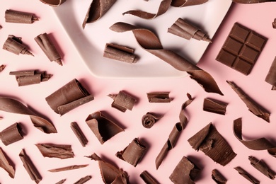 Photo of Flat lay composition with chocolate curls on color background