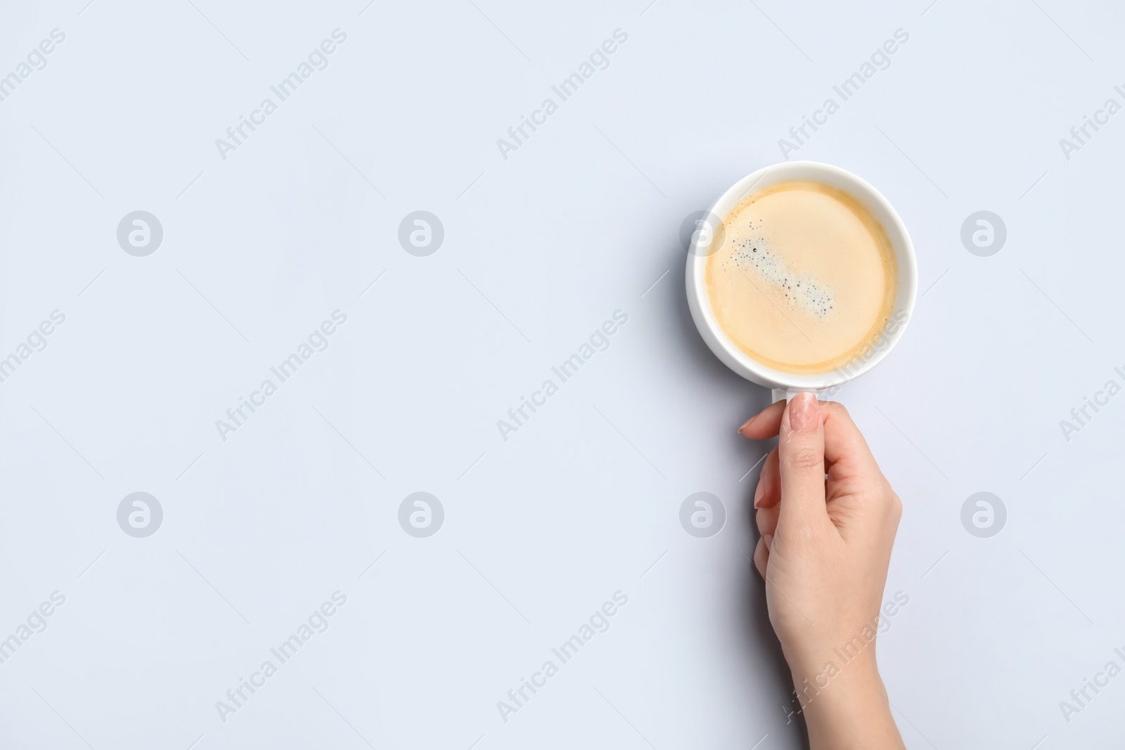 Photo of Woman with cup of coffee on white background, top view