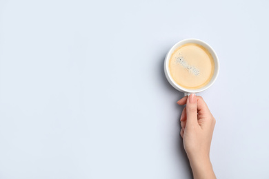 Photo of Woman with cup of coffee on white background, top view