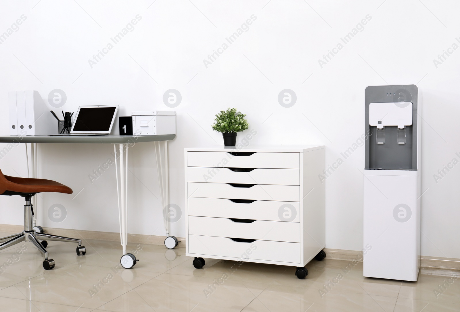 Photo of Modern water cooler in stylish office interior