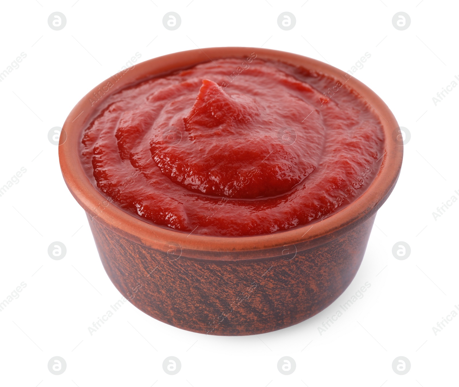 Photo of Tasty ketchup in bowl isolated on white, closeup