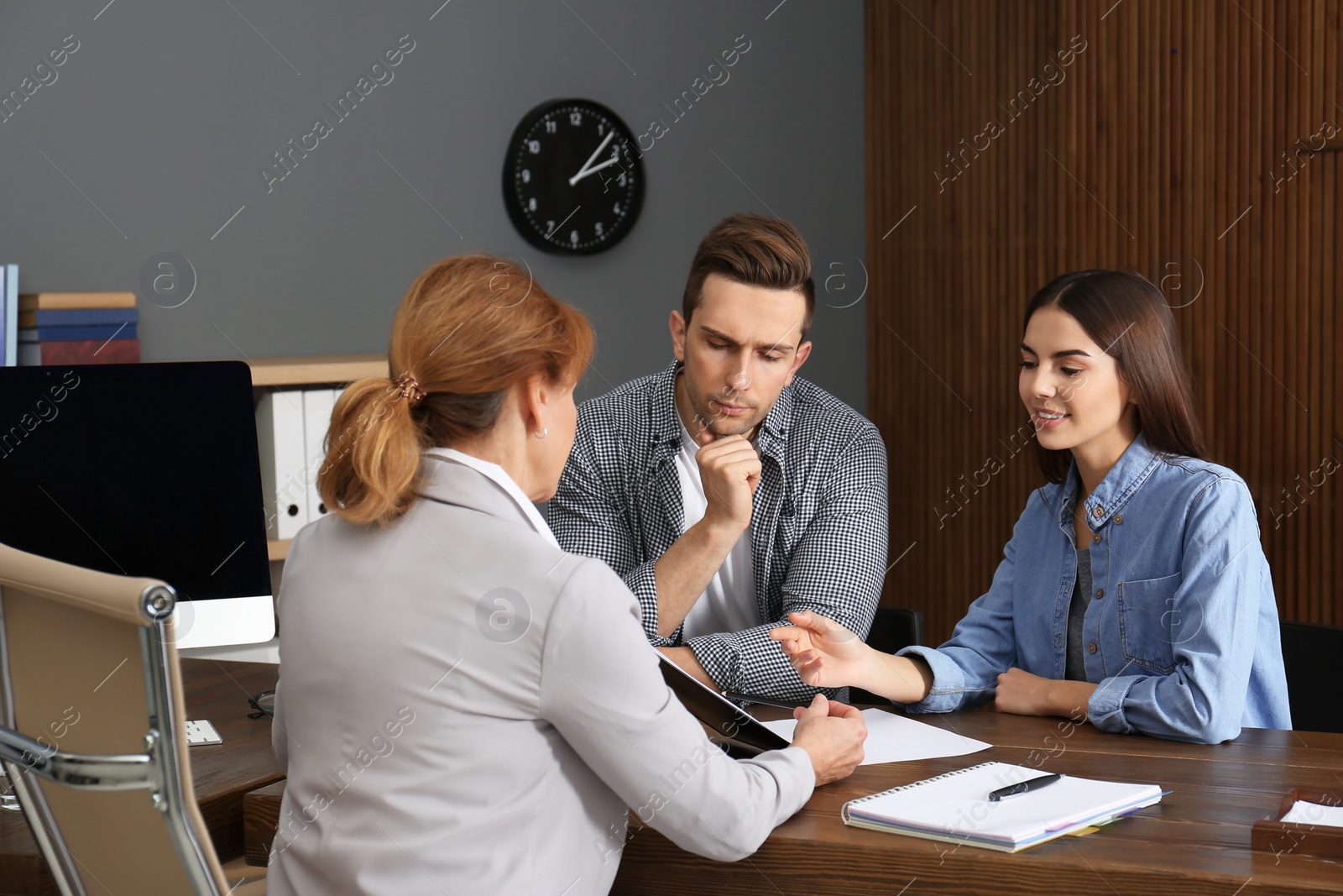 Photo of Lawyer having meeting with young couple in office