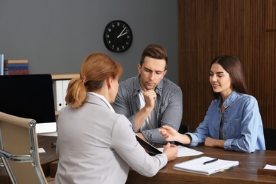 Photo of Lawyer having meeting with young couple in office