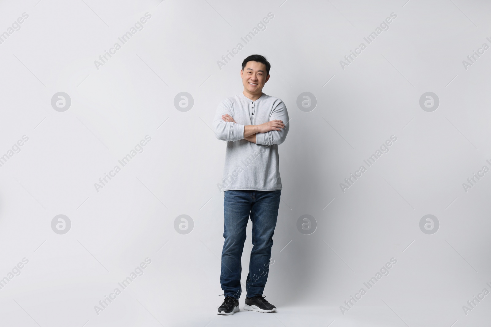 Photo of Full length portrait of happy man on light background