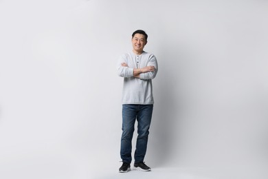 Photo of Full length portrait of happy man on light background