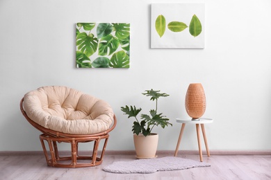 Photo of Stylish room interior with tropical leaves and papasan chair