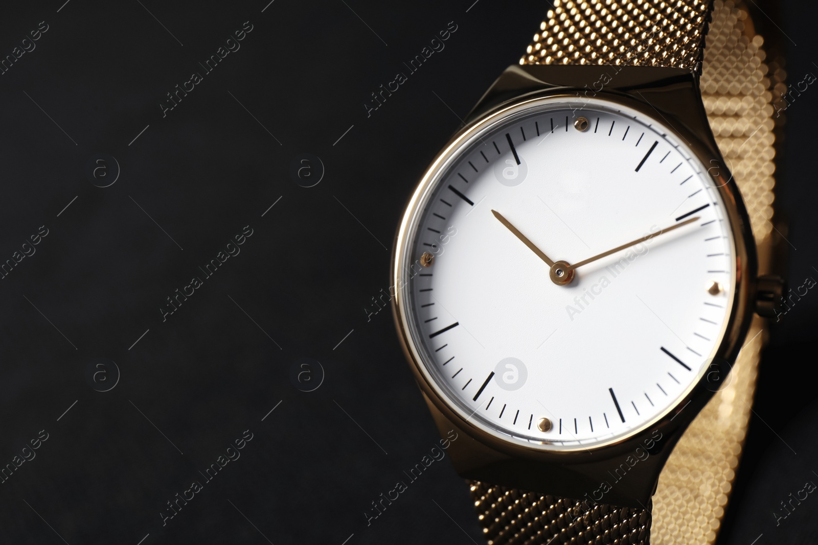 Photo of Luxury wrist watch on black background, closeup. Space for text