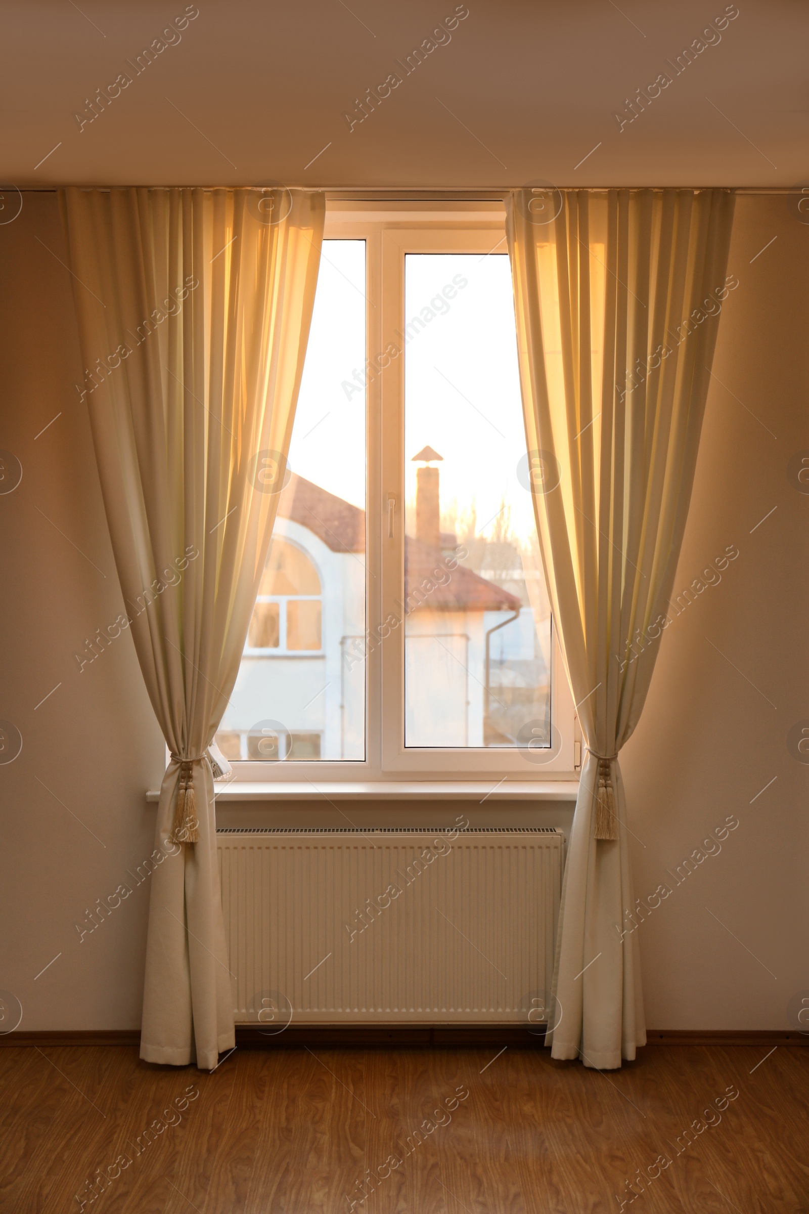 Photo of Window with beautiful curtains in empty room