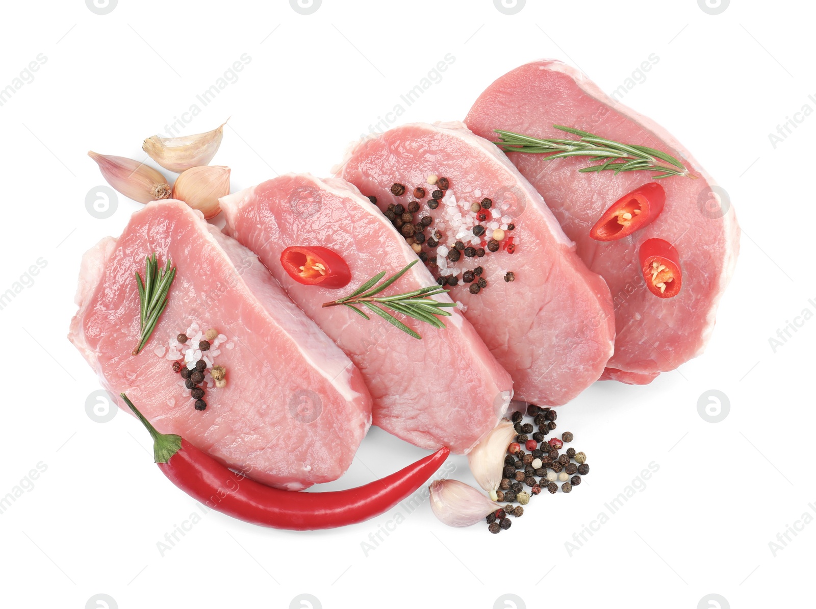 Photo of Pieces of raw pork meat, chili peppers and spices isolated on white