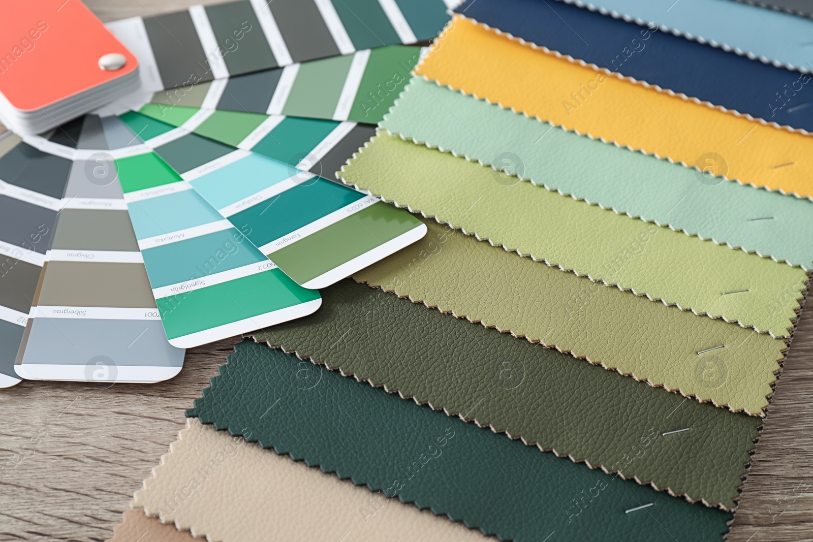 Photo of Upholstery fabric samples and color palette on table. Interior design