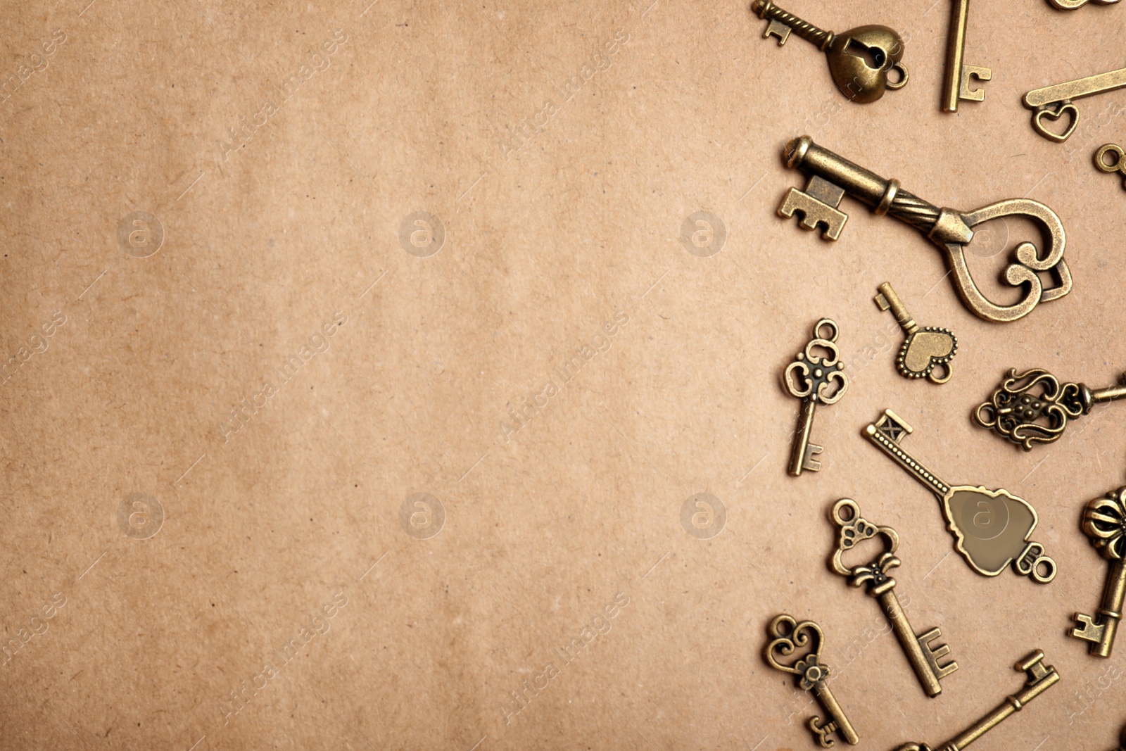 Photo of Old vintage keys on craft paper, flat lay. Space for text