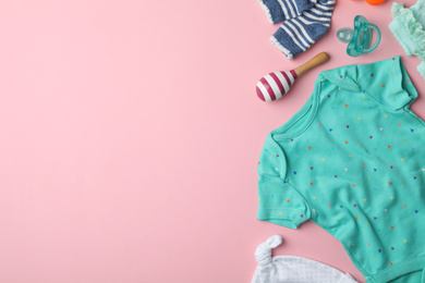 Flat lay composition with child's clothes and accessories on pink background, space for text