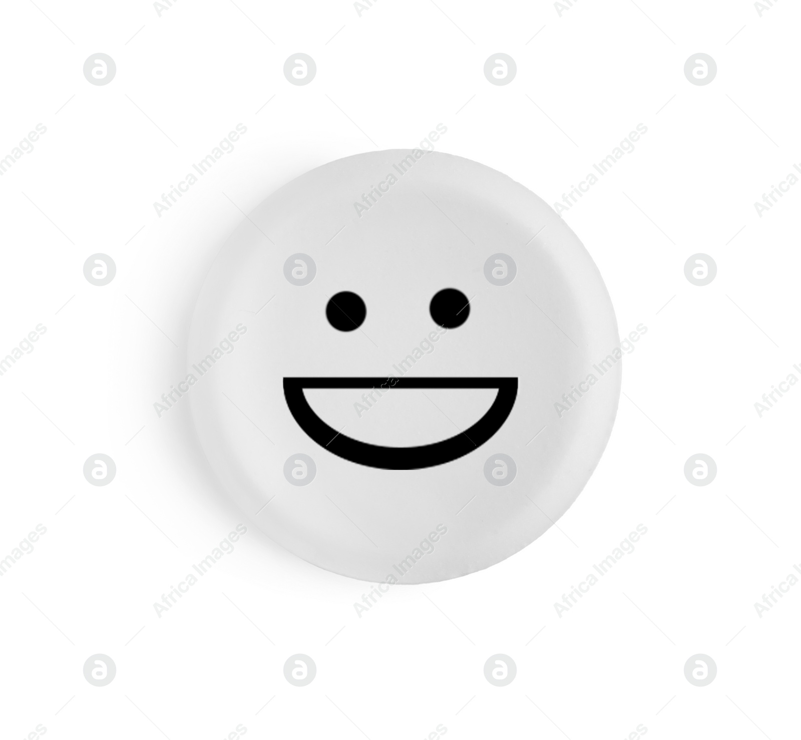 Image of One round pill with smiling face on white background