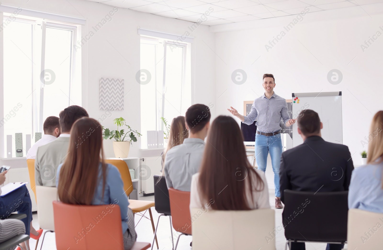 Photo of Male business trainer giving lecture in office