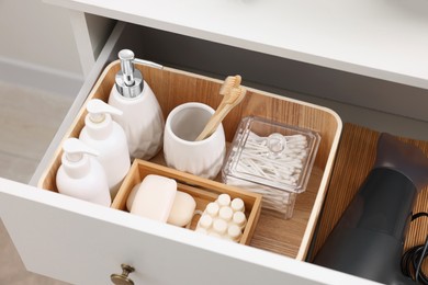 Photo of Different bath accessories and personal care products in drawer indoors, above view