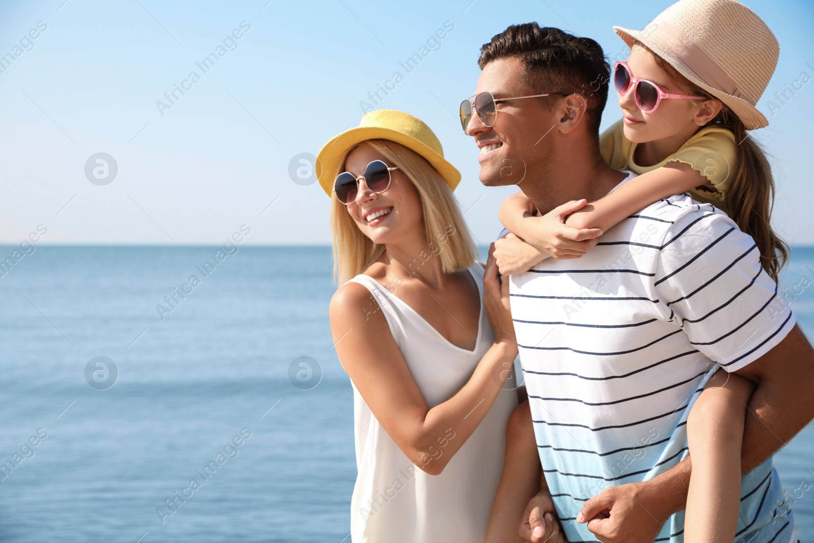 Photo of Happy family at beach on sunny summer day