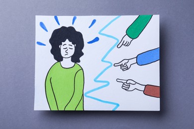 Photo of Drawing of people bullying sad woman on grey background, top view