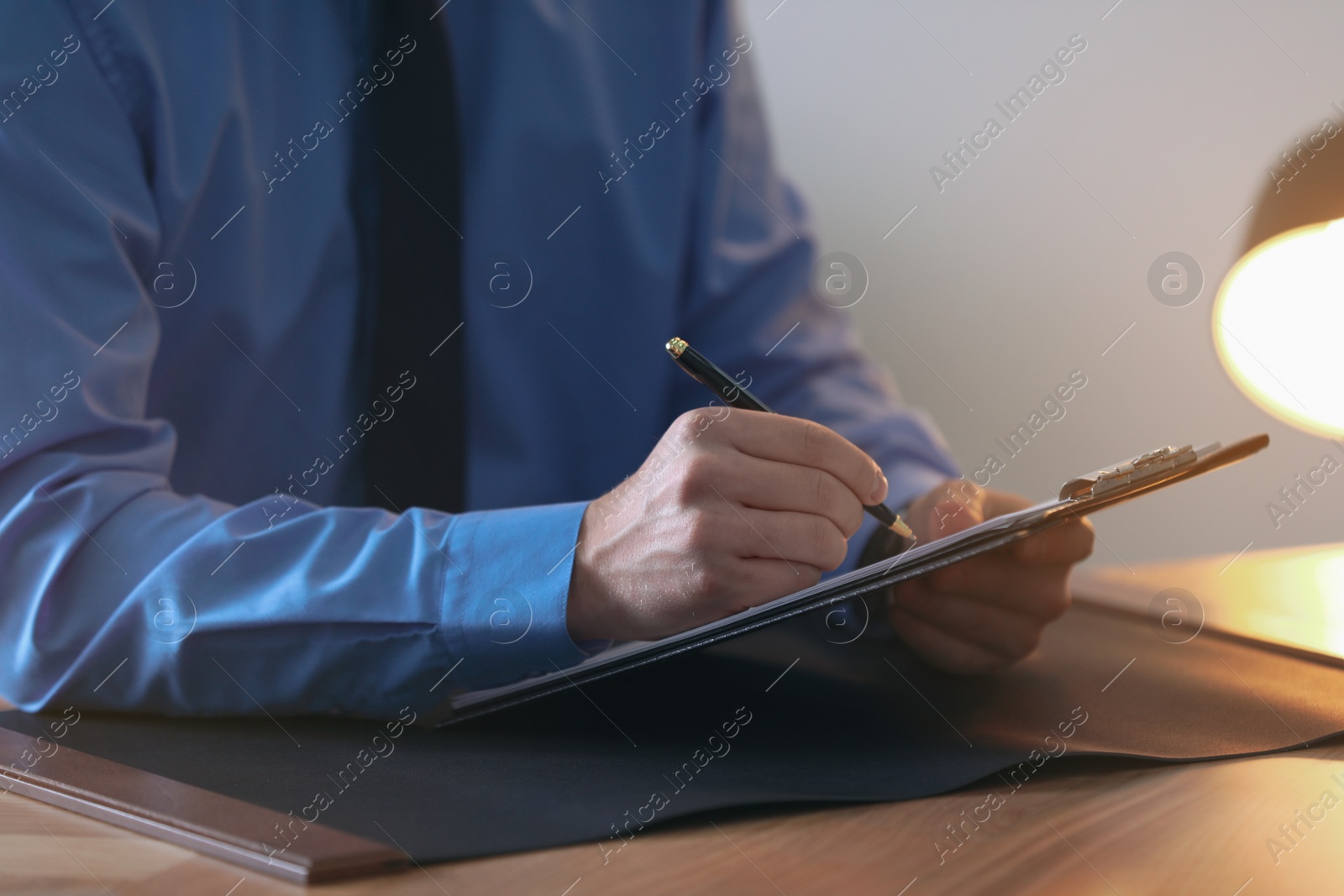 Photo of Male lawyer working at table in office, closeup