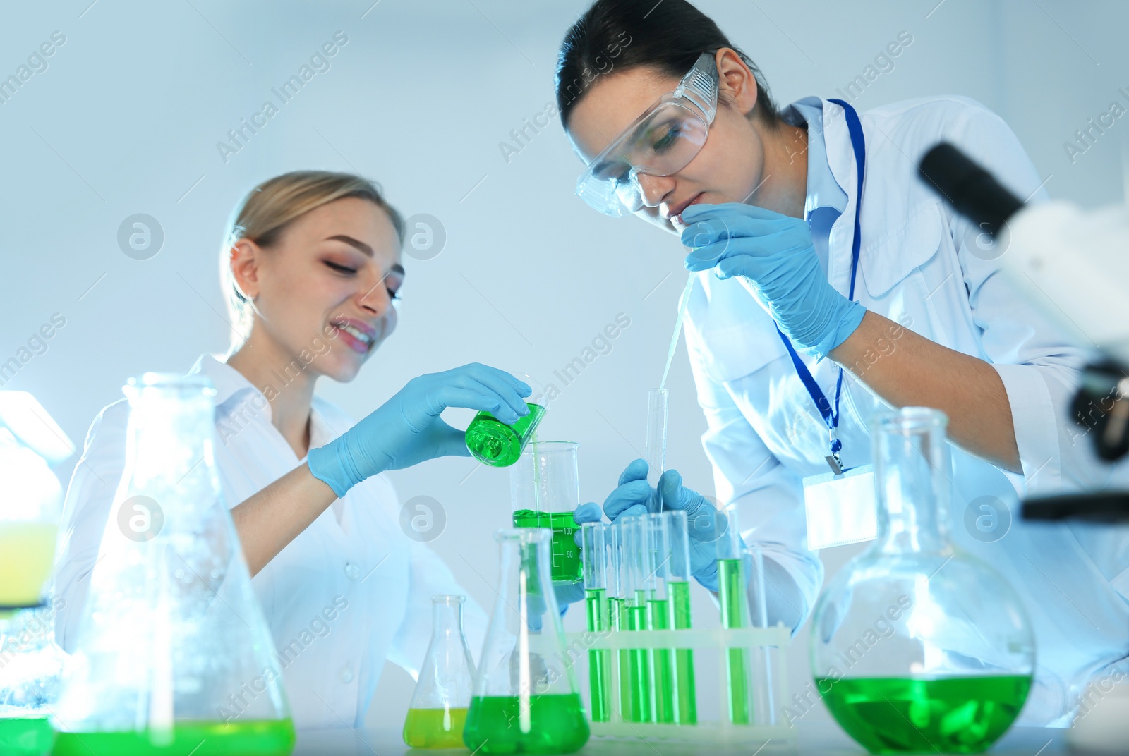 Photo of Female scientists working with sample in chemistry laboratory