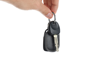 Photo of Man holding key on white background, closeup. Car buying