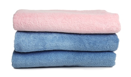 Photo of Folded soft terry towels on white background