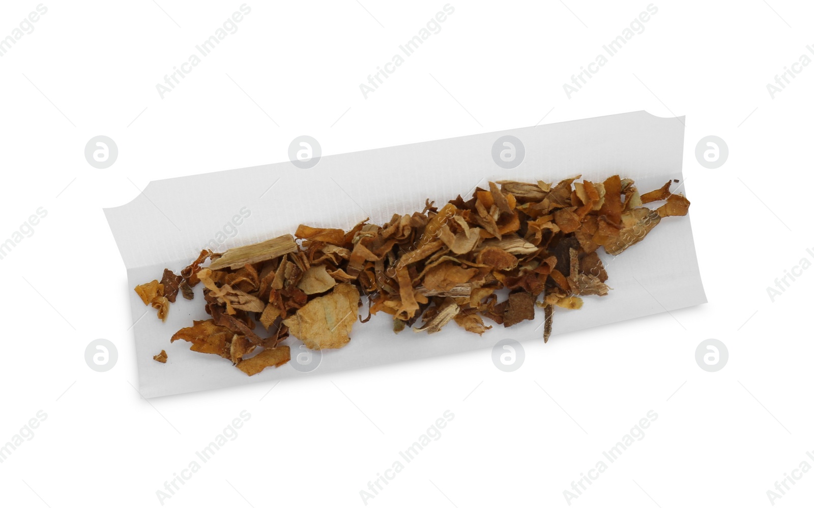 Photo of Making hand rolled cigarette. Paper with tobacco isolated on white.