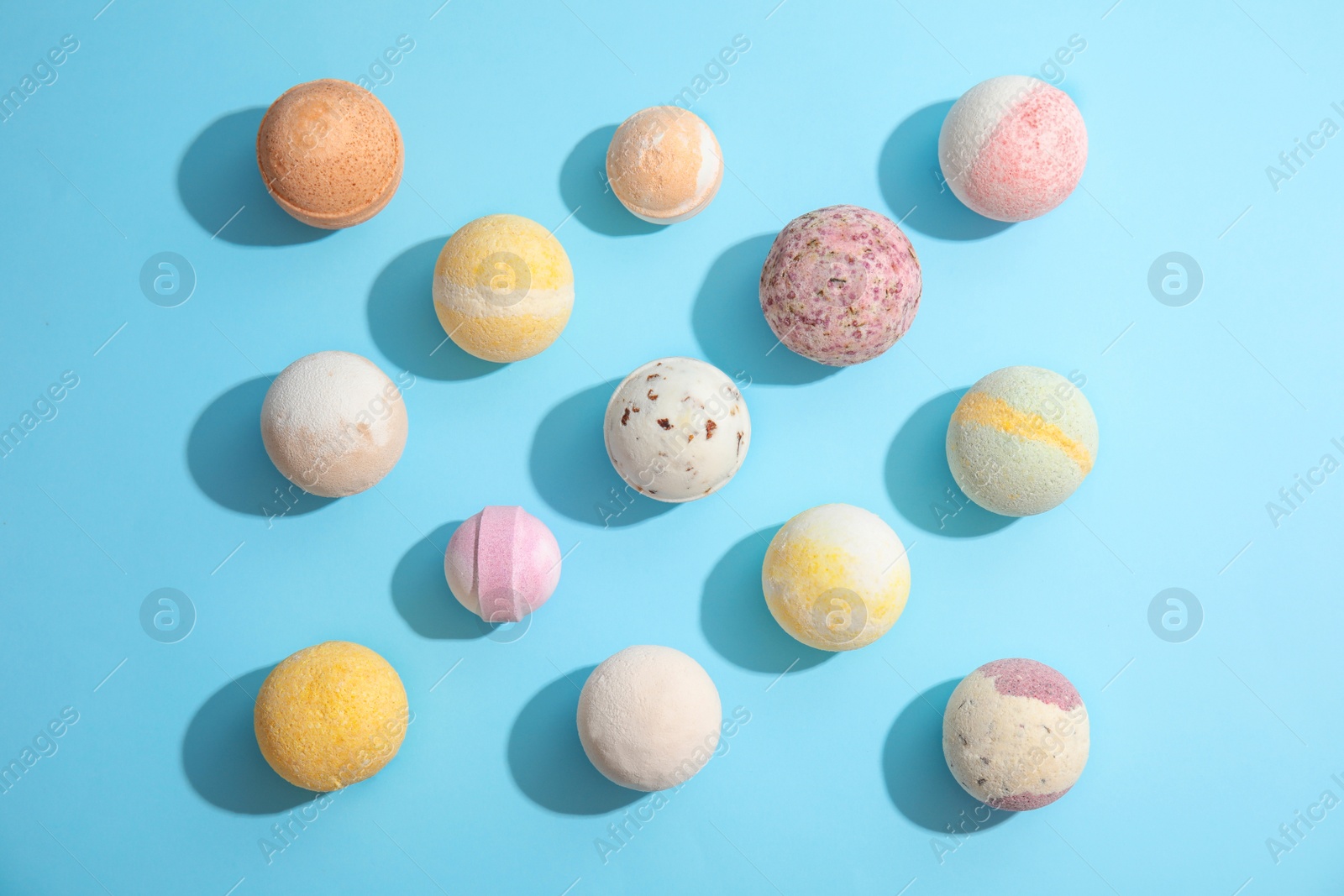 Photo of Flat lay composition with bath bombs on color background