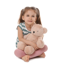 Photo of Portrait of cute little girl with teddy bear on white background