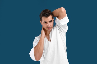 Portrait of handsome young man on blue background