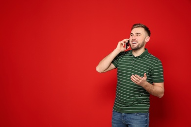 Photo of Portrait of man talking on phone against color background. Space for text