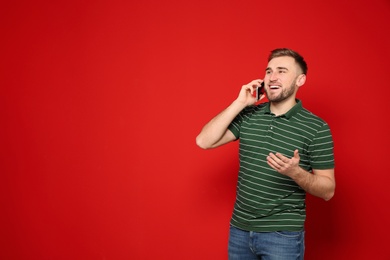 Portrait of man talking on phone against color background. Space for text