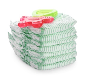 Photo of Stack of disposable diapers and teether on white background. Baby accessories