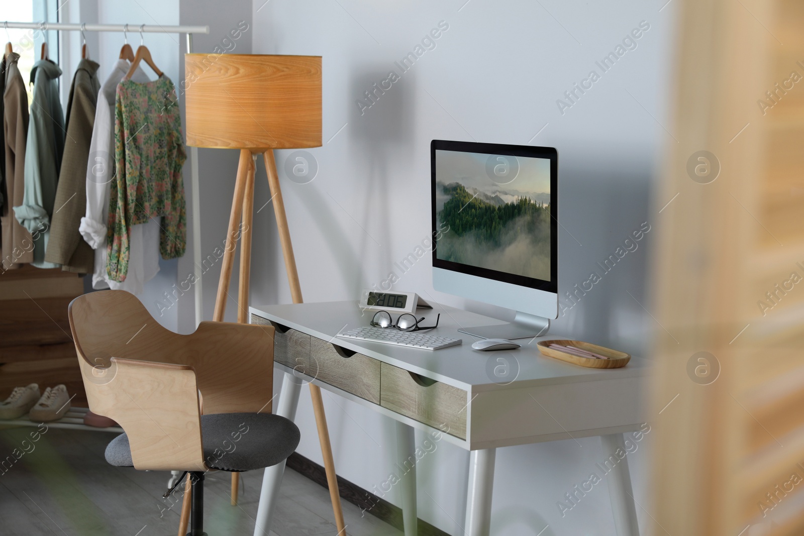 Photo of Stylish room interior with comfortable workplace near white wall