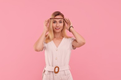 Photo of Portrait of beautiful hippie woman on pink background