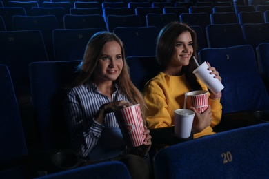Photo of Young women watching movie in cinema theatre