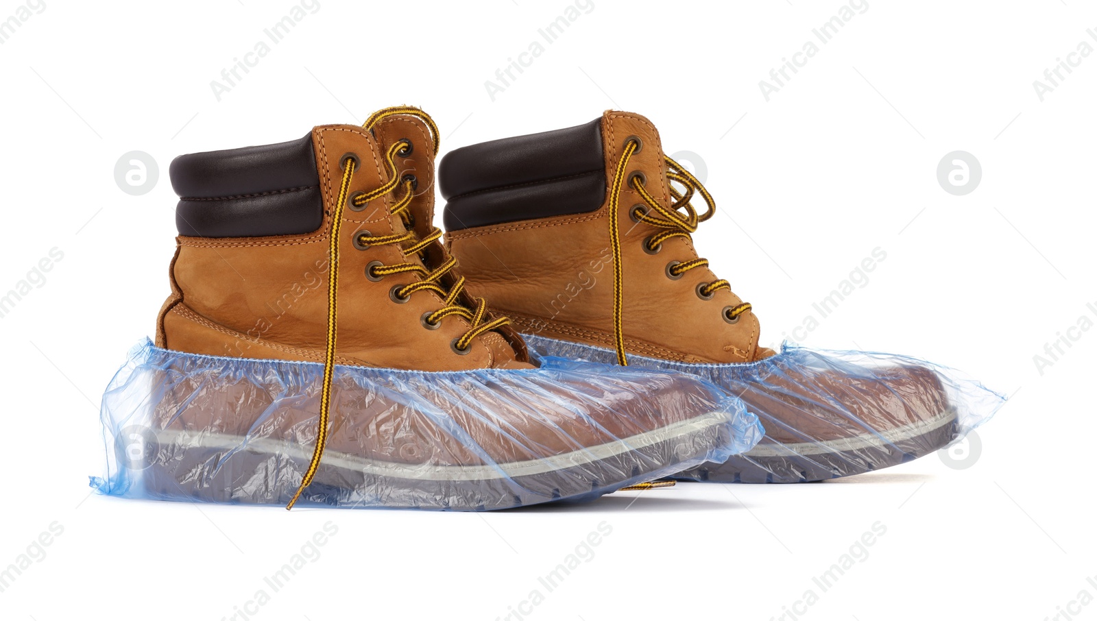 Photo of Boots in blue shoe covers isolated on white