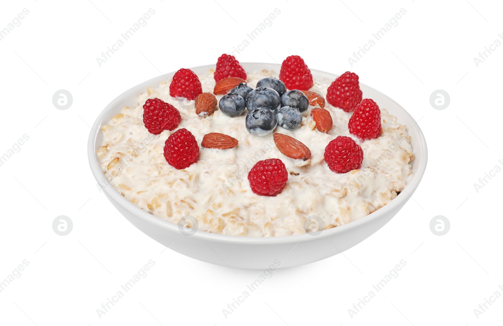 Photo of Tasty boiled oatmeal with berries and almonds in bowl isolated on white