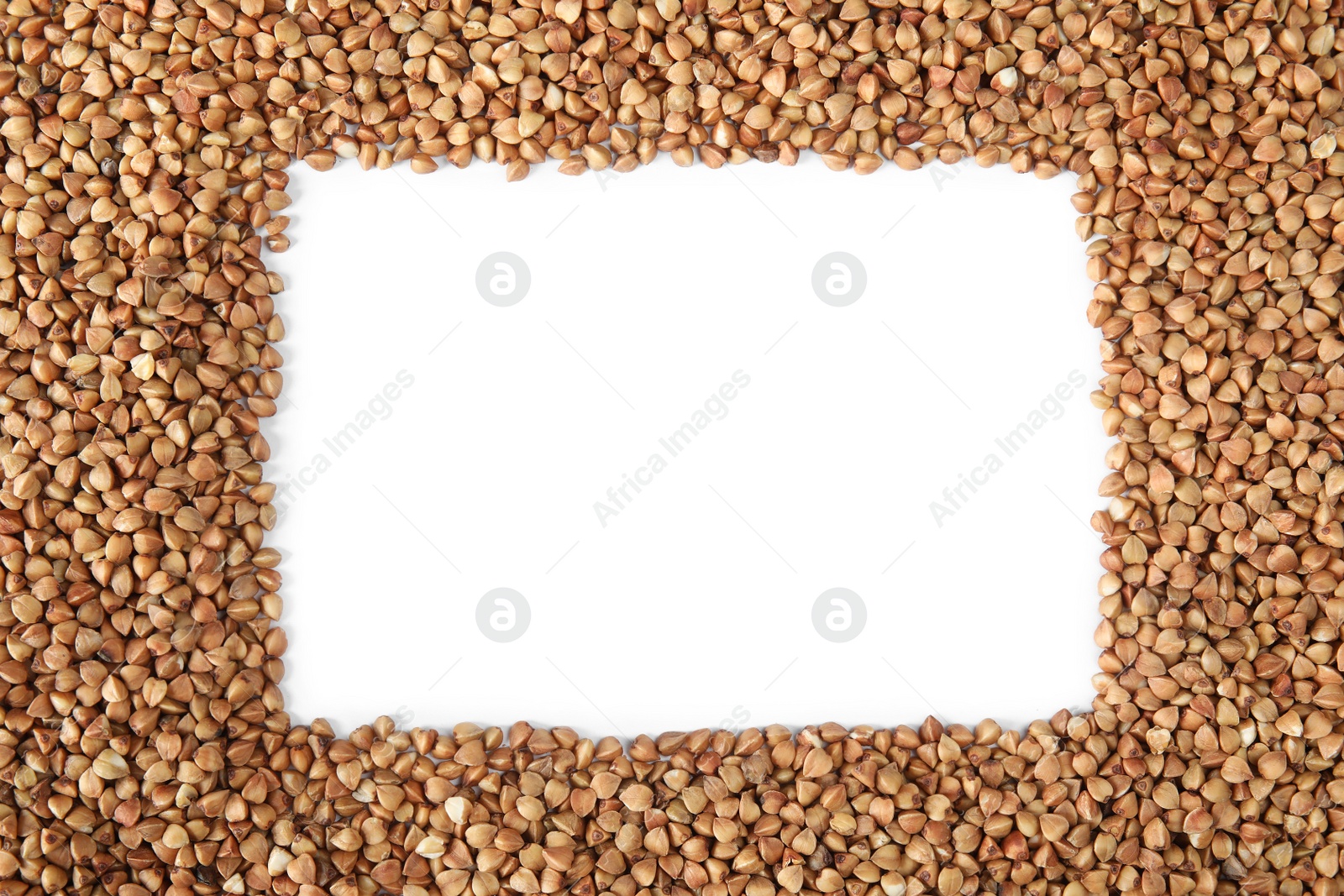 Photo of Frame made of uncooked buckwheat on white background, top view