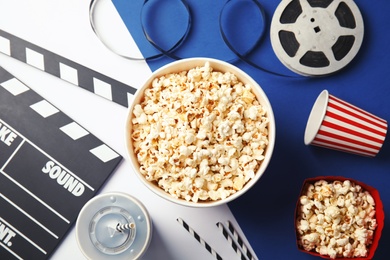 Photo of Flat lay composition with popcorn on color background. Cinema snack